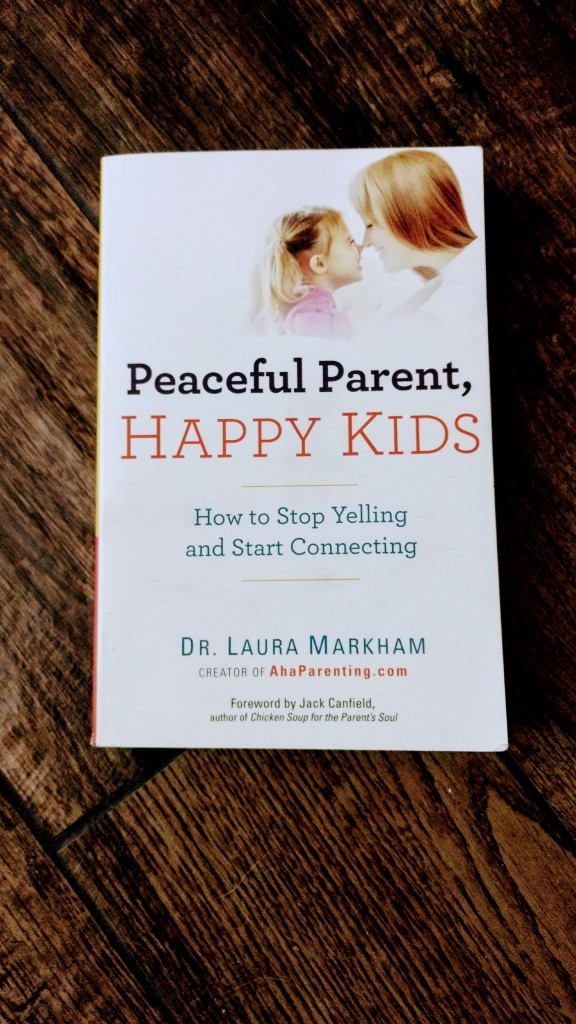 "Peaceful Parent, Happy Kids" book on hardwood floor
